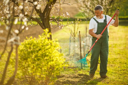 Gardening crew working with tools near a property boundary